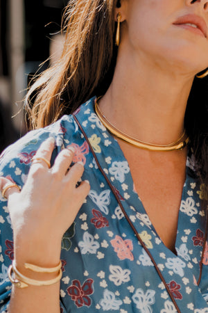 Detailing of gold plated serpent earrings, choker and bracelet cuff