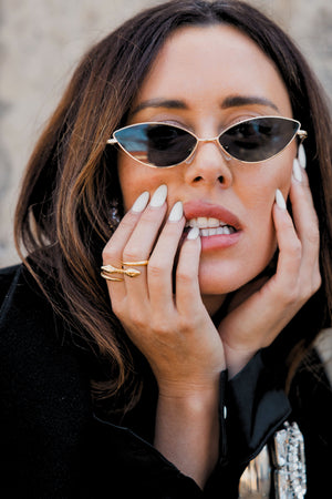 Gold plated serpente ring paired with cat eye sunglasses